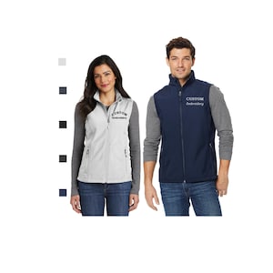 May include: Two people wearing custom embroidered vests. One vest is white, the other is navy blue. Both vests have a zipper closure and a high collar. The vests are worn over long-sleeved shirts and jeans.
