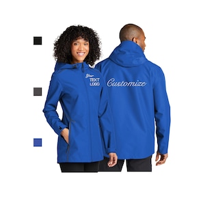 May include: Two people wearing matching royal blue hooded jackets. The front jacket has the text "Your TEXT LOGO" embroidered on the chest. The back of the other jacket has the word "Customize" embroidered in a cursive font. The jackets have zippered pockets.