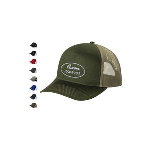 May include: Olive green trucker hat with a mesh back and a curved brim. The hat features the text "Custom LOGO & TEXT" in a white oval. Several color options are displayed to the left of the hat.