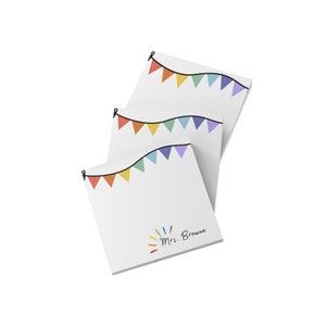 May include: Three white square notepads with a colorful banner design at the top. The bottom of the notepad has the text "Mrs. Browne" in a handwritten font. The banner includes red, orange, yellow, green, blue, and purple triangles.
