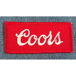 May include: Red rectangular patch with white embroidered text that reads "Coors".
