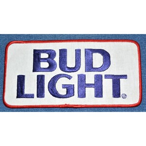 May include: A white embroidered patch with a red border. The patch features the text "BUD LIGHT" in blue lettering.