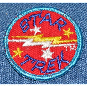 May include: A red, white, and yellow embroidered patch with the words "Star Crew" and a lightning bolt design. The patch is surrounded by a blue border.