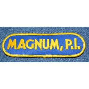 May include: A blue and gold embroidered patch with the text "MAGNUM, P.I."