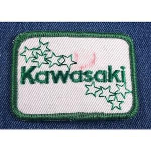 May include: Green embroidered patch with the word "Kawasaki" in white lettering and green stars around the word.