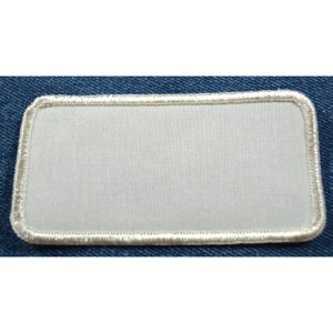 May include: A white rectangular patch with a white stitched border. The patch is blank and ready to be customized.