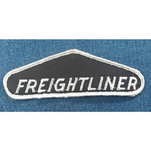 May include: A black and white embroidered patch with the word "FREIGHTLINER" in white lettering on a black background.
