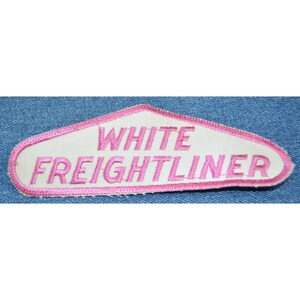 May include: White embroidered patch with pink lettering that reads "White Freightliner".