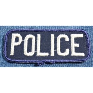 May include: A blue fabric patch with white embroidered lettering that reads "POLICE".