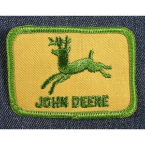 May include: Green embroidered patch with a leaping deer and the text "JOHN DEERE" on a yellow background.