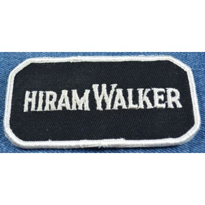 May include: A rectangular patch with the text "HIRAM WALKER" embroidered in white on a black background. The patch has a white border and is set against a blue denim fabric.