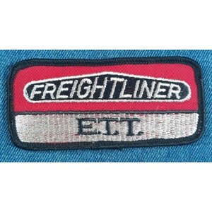 May include: Embroidered patch with the Freightliner logo in white on a red background, with the letters "E.T.T." below on a silver background. The patch is rectangular with a black border.