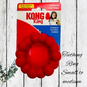 May include: A red KONG Ring dog toy for average chewers. The packaging indicates it's suitable for small to medium dogs, up to 35 lbs. The toy is made of durable, natural rubber. The text on the image says "Teething Ring Small to medium".