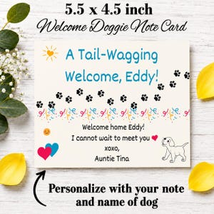 May include: A 5.5 x 4.5 inch rectangular note card featuring the text A Tail-Wagging Welcome, Eddy! with black paw prints, colorful confetti, a yellow sun, a smiling face, two hearts, and a line drawing of a puppy. The card includes the text Welcome home Eddy! I cannot wait to meet you xoxo, Auntie Tina.