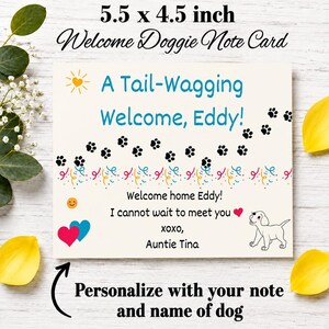 May include: A 5.5 x 4.5 inch rectangular note card featuring the text A Tail-Wagging Welcome, Eddy! with black paw prints, colorful confetti, a yellow sun, a smiling face, two hearts, and a line drawing of a puppy. The card includes the text Welcome home Eddy! I cannot wait to meet you xoxo, Auntie Tina.