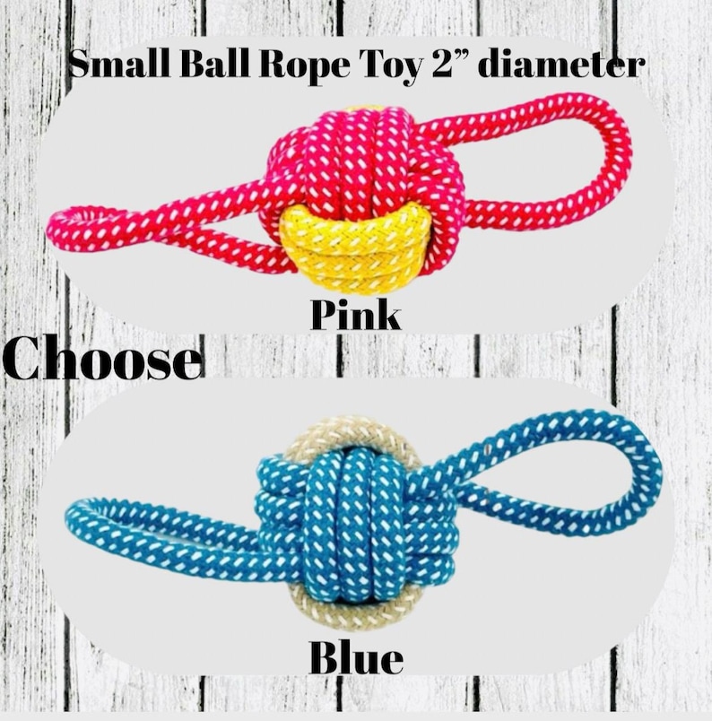 May include: Small ball rope toy, 2" diameter, available in pink and blue. The pink toy has a red and white rope with a yellow center. The blue toy has a blue and white rope with a beige center. The text "Choose" is also visible.
