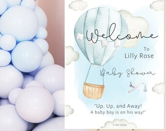 Puede incluir: Un globo aerostático azul y blanco con una cesta y una cigüeña que lleva un cochecito de bebé. El texto "Bienvenido a Lilly Rose Baby Shower" está escrito en el cartel. La fecha "7-20-2023" está escrita en la parte inferior del cartel.