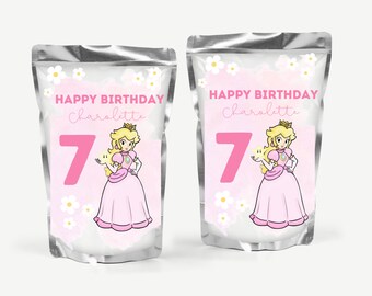 Puede incluir: Dos bolsas plateadas con etiquetas rosas y blancas. Las etiquetas muestran un personaje de princesa de dibujos animados, una estrella y el texto "Happy Birthday Charlotte 7".