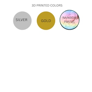 May include: A color chart titled 3D PRINTED COLORS featuring three circular swatches. The first is a solid silver circle labeled SILVER, the second is a solid gold circle labeled GOLD, and the third is a circular gradient of rainbow pastel colors labeled RAINBOW PASTEL.
