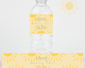 May include: Water bottle label with a yellow sun design and the text "Here comes the sun".