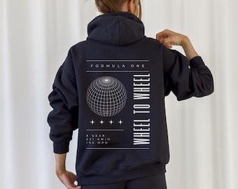 May include: Black hooded sweatshirt with a white graphic print on the back. The graphic features a globe with a grid pattern, the text "Formula One", and the text "Wheel to Wheel". The text below the globe reads "8 Gear, 321 KM/H, 199 MPH".