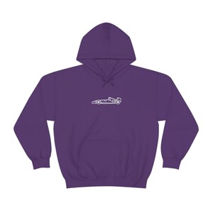 May include: Purple hooded sweatshirt with a white outline of a racing car on the front.