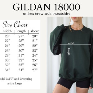 May include: Size chart for a Gildan 18000 unisex crewneck sweatshirt. The chart shows measurements in inches for width, length, and sleeve length for sizes S through 5XL. A model is wearing a size Large.