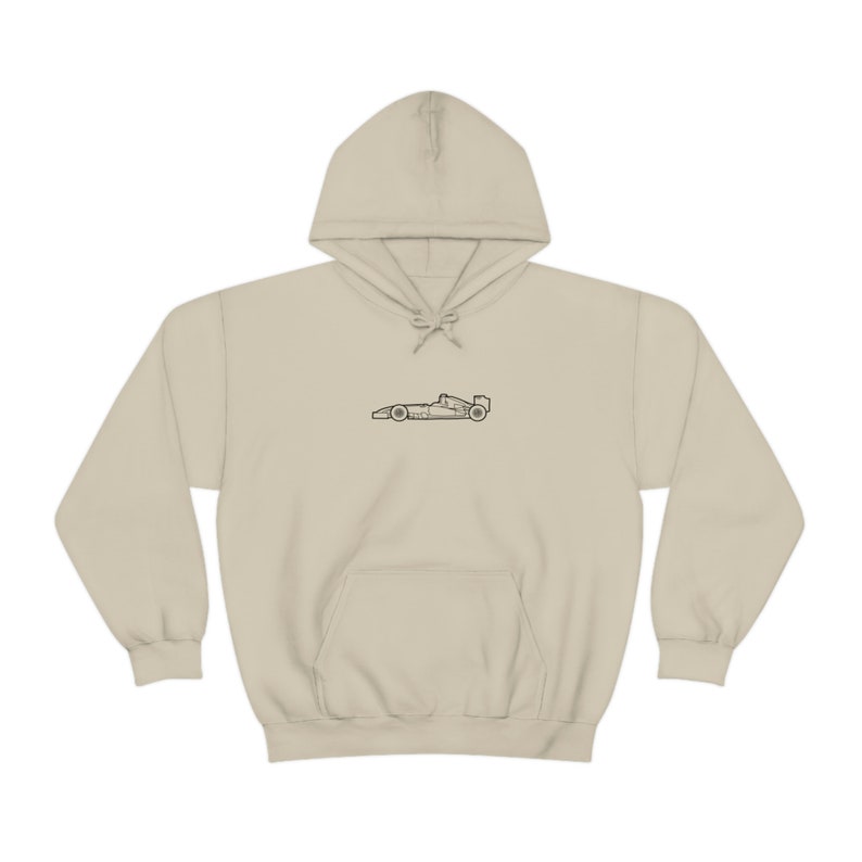 May include: A beige hoodie with a black outline of a racing car on the front.