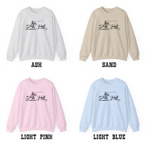 Peut inclure: Quatre sweat-shirts de couleurs diff&eacute;rentes&nbsp;: gris cendr&eacute;, sable, rose clair et bleu clair. Chaque sweat-shirt pr&eacute;sente un motif noir et blanc d&rsquo;un cow-boy &agrave; cheval qui l&acirc;che un lasso sur un b&oelig;uf.