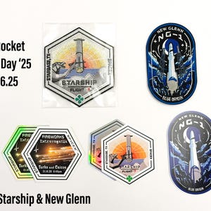 May include: A collection of colorful iron-on patches featuring space-themed designs. The patches include a rocket ship, a space shuttle, and a planet. The patches are perfect for adding a unique touch to clothing, bags, or other accessories.