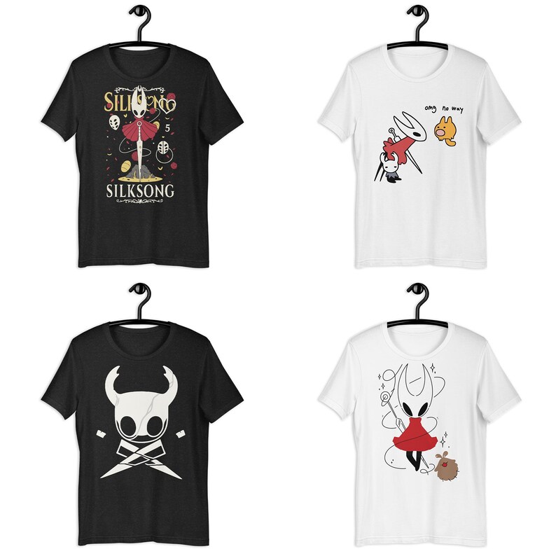 May include: Four short-sleeve t-shirts hanging on black hangers. Two are black and two are white. The shirts feature graphic prints of characters from the video game Hollow Knight, including Hornet and the Knight, with text reading SILKSONG.
