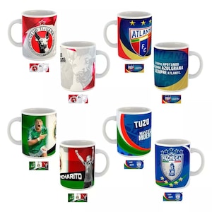 May include: White ceramic mugs with various soccer team logos and graphics. Designs include the Club Tijuana logo, the Atlante FC logo, and the Pachuca Club de F&uacute;tbol logo. Some mugs feature player images and team slogans.