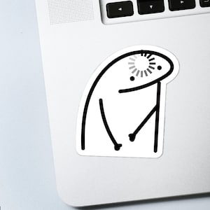 May include: A white sticker featuring a black and white cartoon character with a loading symbol above its head. The character has a simple design with a curved body, two arms, and two small dots for eyes.