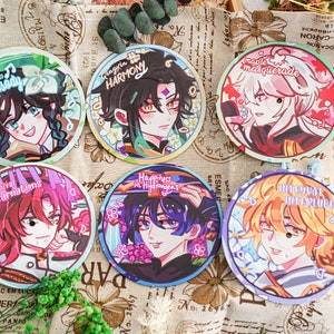 May include: Six round coasters with anime-style character illustrations. Each coaster features a different character with unique hair and clothing, surrounded by floral or decorative elements. Text includes phrases like "Rhapsody" and "Harmony".