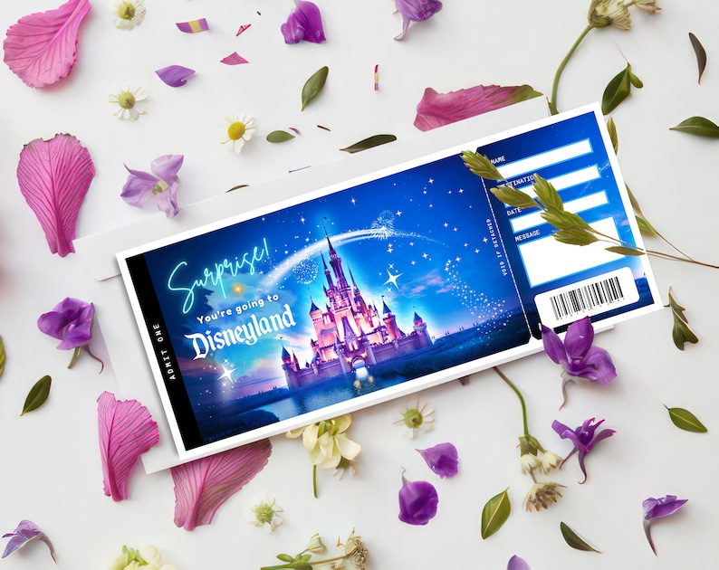 May include: A Disneyland ticket with a blue background featuring a castle, fireworks, and the words "Surprise! You're going to Disneyland." The ticket is inside a white envelope, surrounded by flower petals and small flowers.