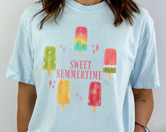 May include: A light blue t-shirt with a graphic of colorful popsicles and the text "Sweet Summertime".