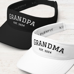May include: Two black and white visor hats with the words "Grandpa Est. 2024" and "Grandma Est. 2024" embroidered on them.