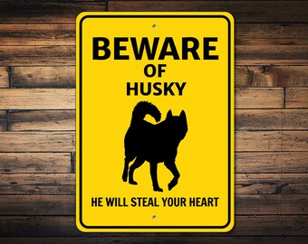 May include: Yellow warning sign with black text that reads "Beware of Husky. He will steal your heart." A black silhouette of a husky dog is in the center of the sign.