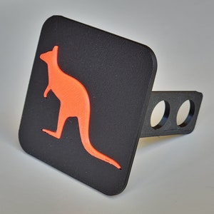 May include: Black hitch cover with an orange kangaroo silhouette.