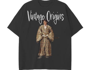 May include: Black t-shirt with the text "Vintage Origins" in white script. The shirt features an image of a person in a patterned kimono and holding a sword. The shirt has short sleeves and a crew neck.