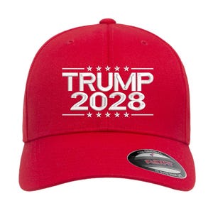 May include: A red baseball cap with the text "TRUMP 2028" in white, with stars above and below the text. The cap has a curved brim and a Flexfit tag.