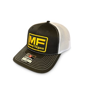 May include: Black and white trucker hat with a yellow and gold embroidered patch that says "MF Massey Ferguson".