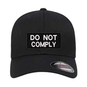 May include: Black baseball cap with a white patch that says "DO NOT COMPLY".