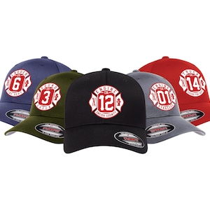 May include: Five baseball caps in navy, olive green, black, gray, and red. Each cap features a white emblem with a number and text, including "Ladder 6 Fire Dept," "Squad 3 Chuck," "Engine 12 Oneida County," "Engine 01 Syracuse," and "Truck 14 Cicero Fire Dept."