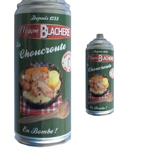 Puede incluir: Una lata plateada con una etiqueta verde y roja. La etiqueta presenta una foto de un tazón de chucrut con salchicha y tocino. El texto en la etiqueta dice "La Maxim BLACHERE Choucroute" y "En Bombe!"