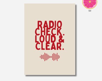 May include: A rectangular print with the words "RADIO CHECK. LOUD & CLEAR." in red, along with a sound wave graphic. The print is on a cream-colored background. The PomeloPrintsShop logo is in the upper right corner.