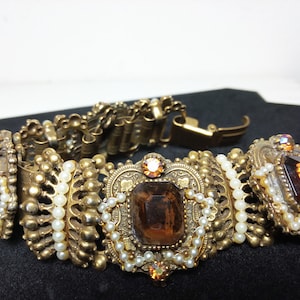 May include: A rustic wooden sign with the text "Welcome to our home" in white lettering. The sign features a distressed finish and a simple, inviting design, perfect for a front porch or entryway.