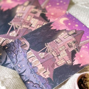 May include: A whimsical illustration of a multi-story house with a crescent moon and stars in the night sky. The house is surrounded by trees and bushes, and there are small details like windows and a chimney. The illustration is done in a soft purple and pink color palette.