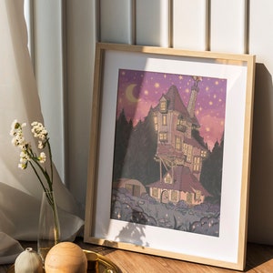May include: A framed illustration of a whimsical, multi-colored house with a chimney and a crescent moon in the sky. The house is surrounded by trees and stars. The illustration is set against a purple and pink background.