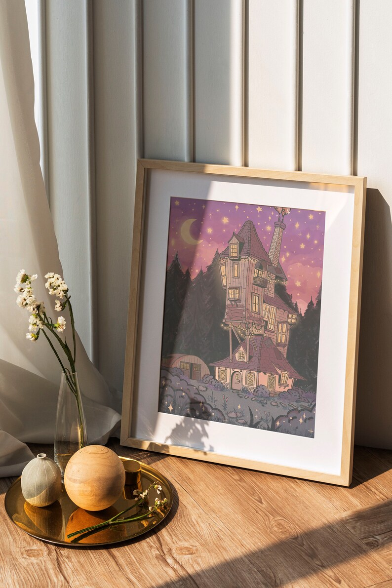 May include: A framed illustration of a whimsical, multi-colored house with a chimney and a crescent moon in the sky. The house is surrounded by trees and stars. The illustration is set against a purple and pink background.